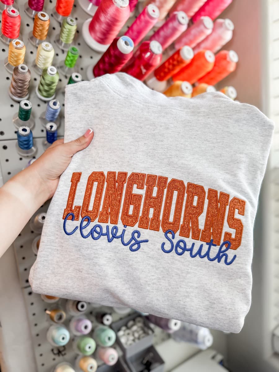 Gray sweatshirt with Longhorns Clovis South glitter and script embroidery