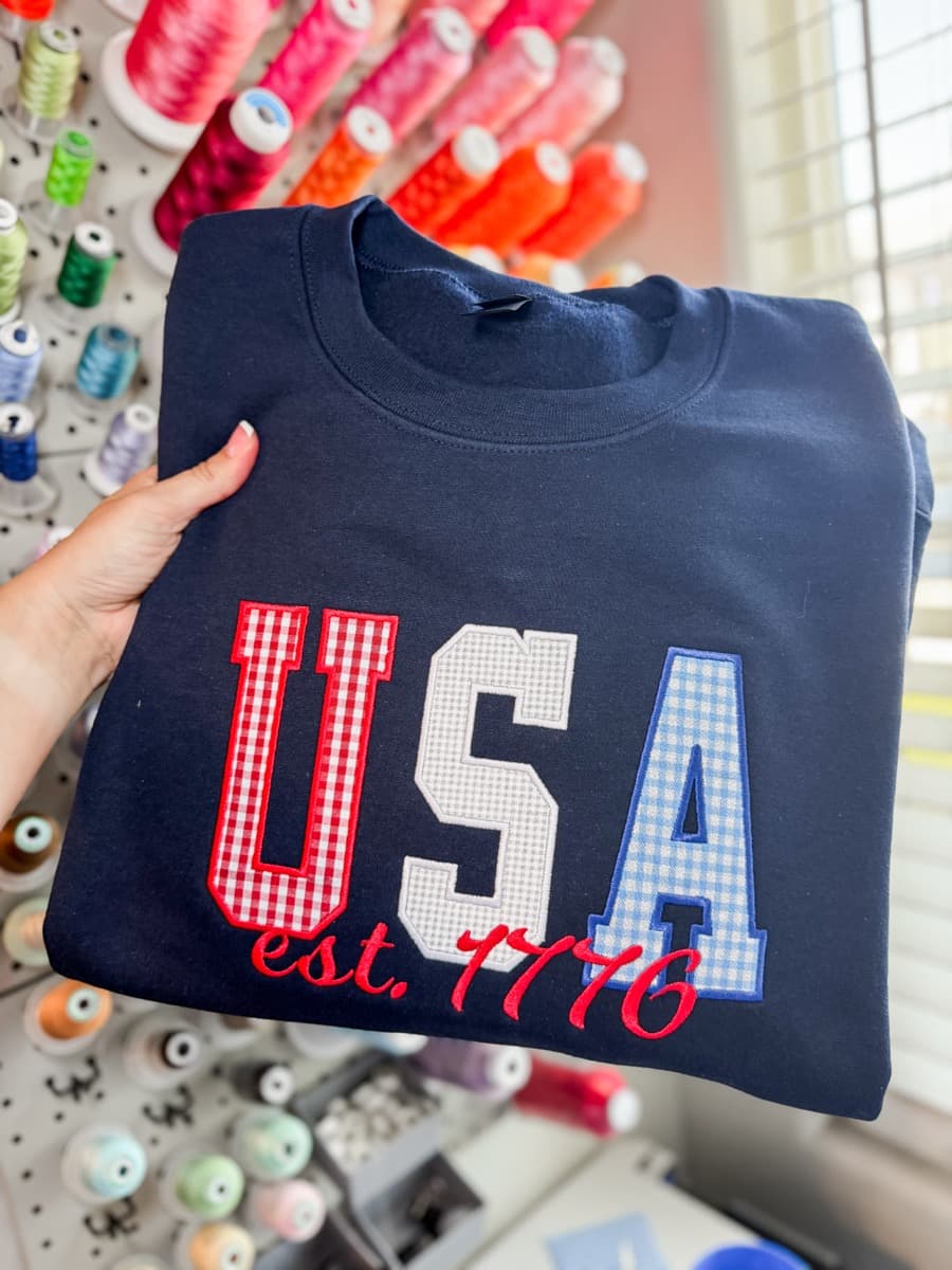 Navy crewneck with appliqué USA lettering and est. 1776 embroidery