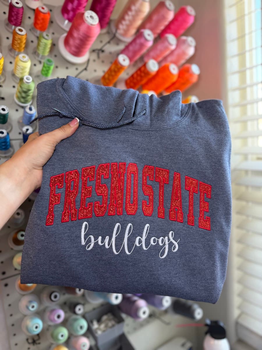 Charcoal hoodie with red glitter Fresno State and white bulldogs script embroidery