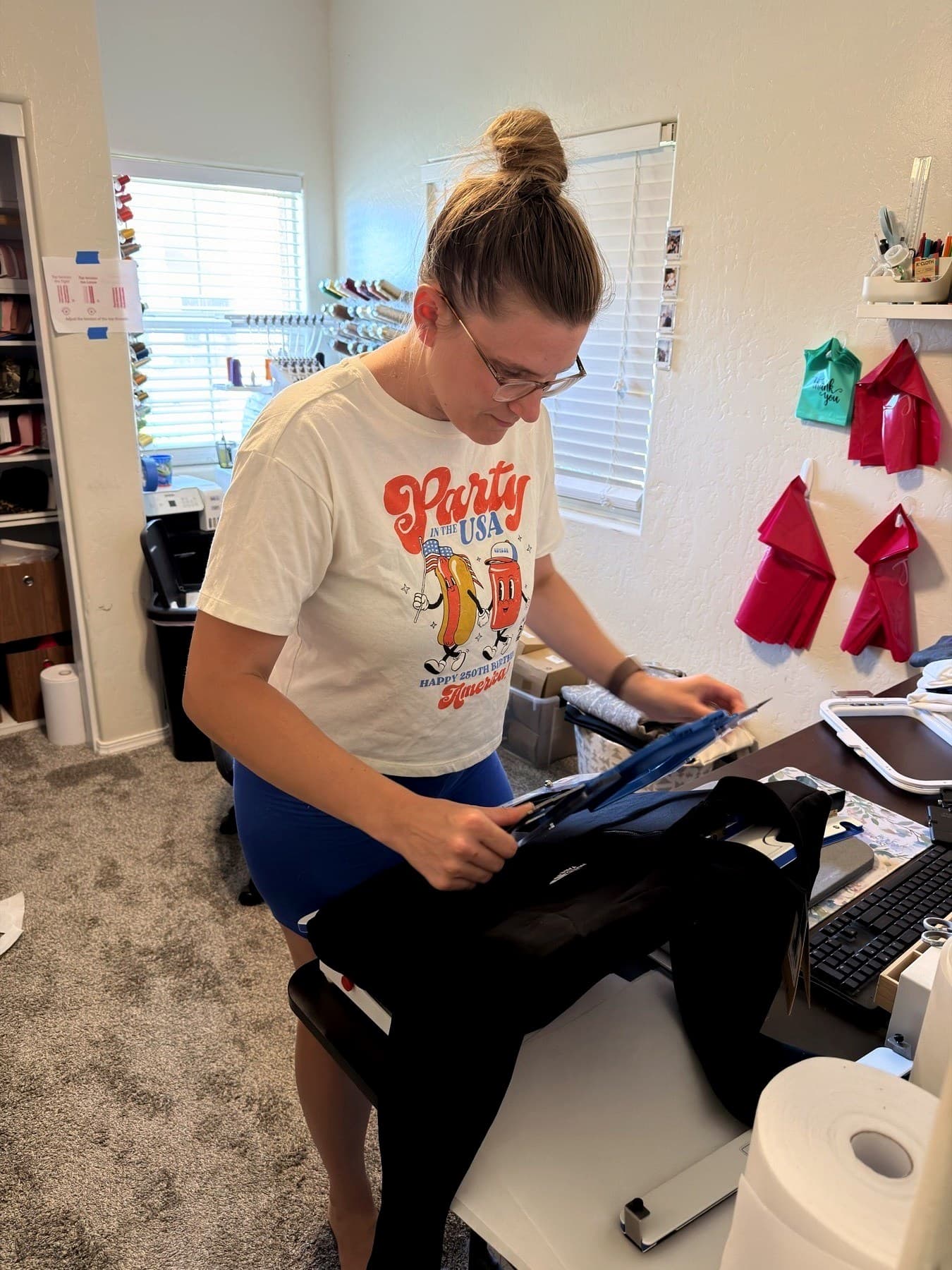 Jennifer Lorin cutting fabric in her studio